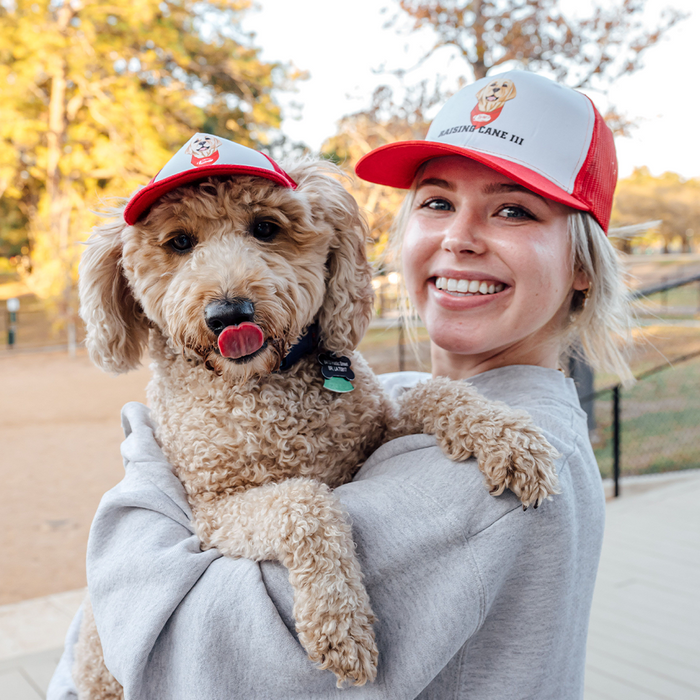 Cane III Trucker Hat on Model with Labradoodle