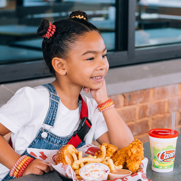 Raising Cane's TELETIES on Child Model's Wrist and Hair