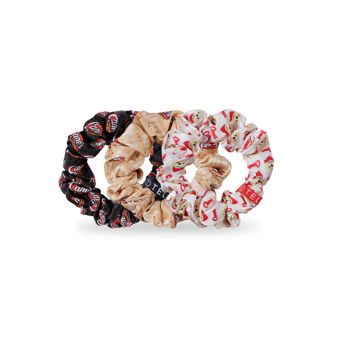 Three Raising Cane's x TELETIES scrunchies with different patterns on a white background