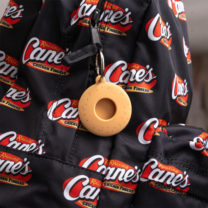 Back of Cane's Sauce Key Tag Holder on black Raising Cane's backpack