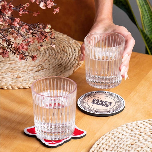 Lifestyle photo of dog coaster and canes sauce coaster being used.