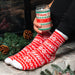 Lifestyle photo of holiday can glass and holiday socks