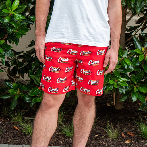 Boardshorts with Cane's Logo in Red on Model